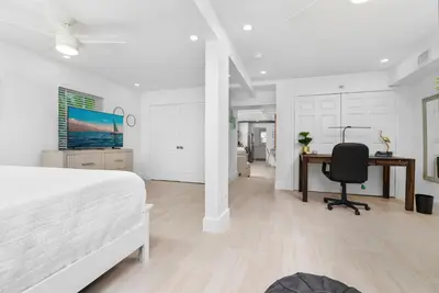 a white bedroom with a desk and a bed at The Riverside Retreat 1 in Fort Lauderdale