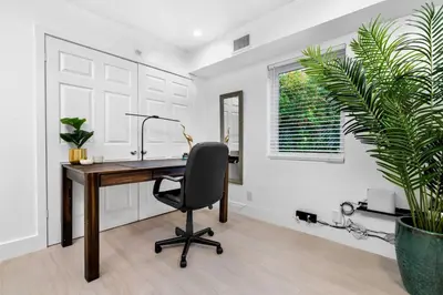 an office with a desk and a chair and a plant at The Riverside Retreat 1 in Fort Lauderdale