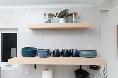 a shelf with blue bowls and plates on it at The Riverside Retreat 1 in Fort Lauderdale