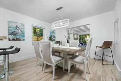 a dining room with a table and chairs at The Riverside Retreat 2 in Fort Lauderdale
