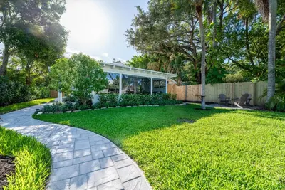 a garden with a walkway leading to a house at The Riverside Retreat 2 in Fort Lauderdale