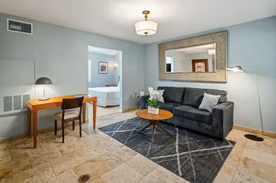 a living room with a couch and a table at Kasa La Flora And Impala Miami Beach in Miami Beach