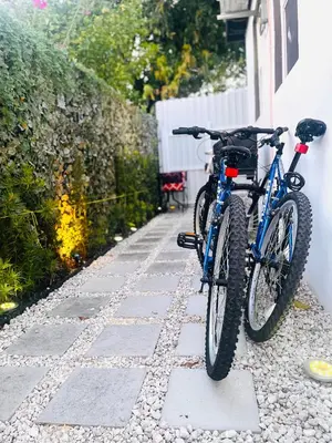 a bike parked on a sidewalk next to a house at Guesthouse w Bikes near Wynwood in Miami