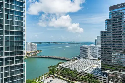 a view of the ocean between two tall buildings at ICON Brickell Miami- 2 bedroom Condo with City and water views! in Miami