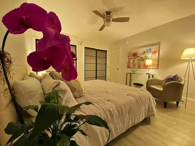 a bedroom with a bed with a large purple flower at Block from Beach one bedroom with Parking in Miami Beach