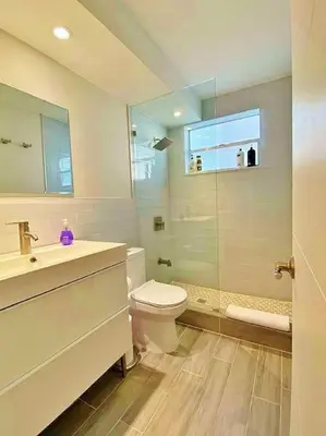 a bathroom with a toilet and a sink and a shower at Block from Beach one bedroom with Parking in Miami Beach