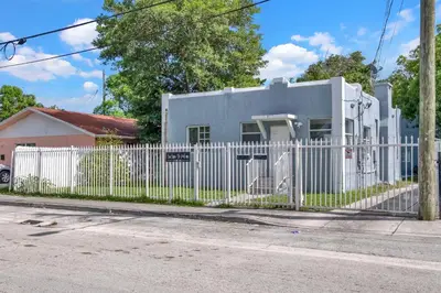 a white fence in front of a house at Dos Casitas Design District #1 - 3 Bedroom House in Miami