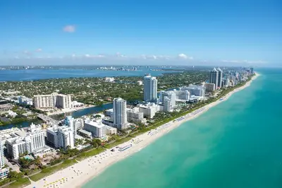 an aerial view of a beach with buildings and the ocean at Sky-High oasis Large Studio POOL & GYM in Miami