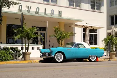 a blue car parked in front of a building at Sky-High oasis Large Studio POOL & GYM in Miami