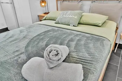 a bed with a towel on top of it at Beachfront & Pool Near Marriott Hollywood Beach in Hollywood
