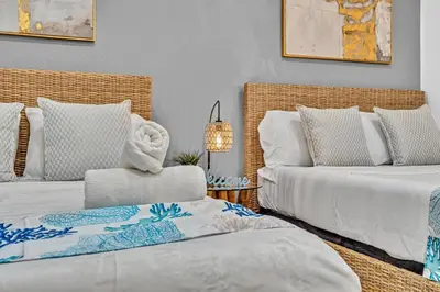a living room with two beds and a chair at Beachfront & Pool Access Unit W 2 Queen Beds in Hollywood