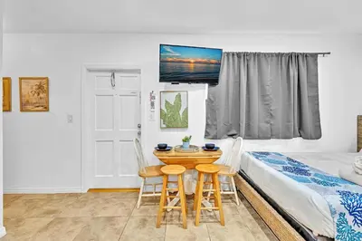 a room with a bed and a table and two chairs at Beachfront & Pool Access Unit W 2 Queen Beds in Hollywood