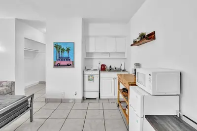 a kitchen with white cabinets and a white appliances at Studio Retreat With 2 Queen Beds Hollywood Blvd in Hollywood