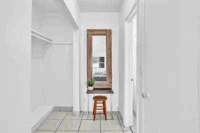 a stool in a hallway with a mirror at Studio Retreat With 2 Queen Beds Hollywood Blvd in Hollywood
