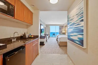 a hotel room with a kitchen and a bedroom at Trump International Beach Resort Deluxe 2 Queen Ocean Front in Sunny Isles Beach