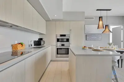 a kitchen with white cabinets and a counter top at Front Intercostal Luxury Apt View Amazing in Hollywood