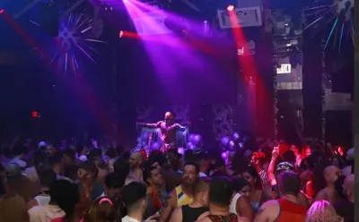 a crowd of people watching a man on a stage at Wilton Manors Guesthouse in Fort Lauderdale