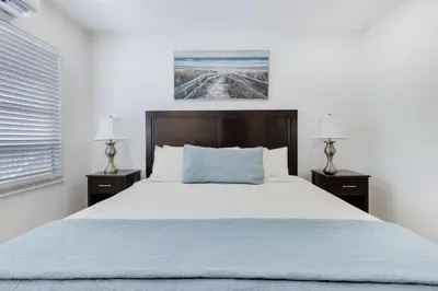 a bedroom with a large bed and two night stands at ULTRA chic apartment steps from the beach in Hollywood
