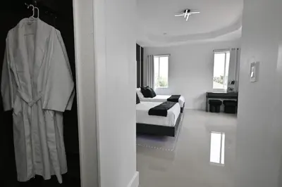 a white room with a bed and a couch at LuxOasis Getaway Minigolf, Pool, Beach, Chess, Jacuzzi in Tamiami