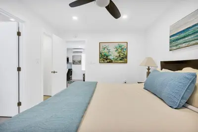a bedroom with a large bed and a ceiling fan at ULTRA Modern Apartment by the Beach in Hollywood