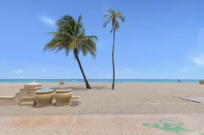a sandy beach with palm trees and a sand castle at ULTRA magical apartment at the Beach in Hollywood