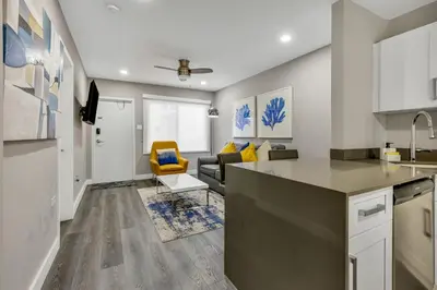 a kitchen and living room with a couch and a table at ULTRA magical apartment at the Beach in Hollywood