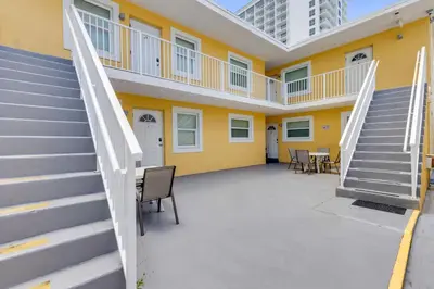 a building with stairs and a yellow wall at ULTRA spacious apartment steps from the beach in Hollywood