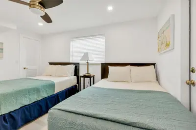 a bedroom with two beds and a ceiling fan at ULTRA joyful apartment perfect for families in Hollywood