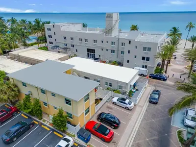an aerial view of a building with a parking lot at ULTRA joyful apartment perfect for families in Hollywood