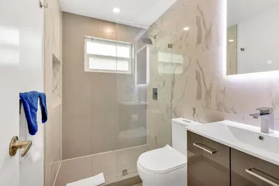 a bathroom with a toilet and a shower and a sink at ULTRA joyful apartment perfect for families in Hollywood
