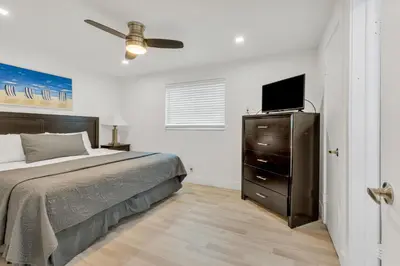 a bedroom with a bed and a television on a dresser at ULTRA joyful apartment perfect for families in Hollywood