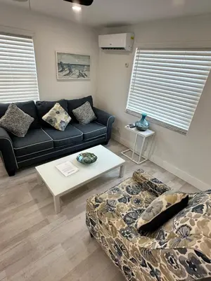 a living room with a couch and a table at ULTRA exciting apartment at the Boardwalk in Hollywood