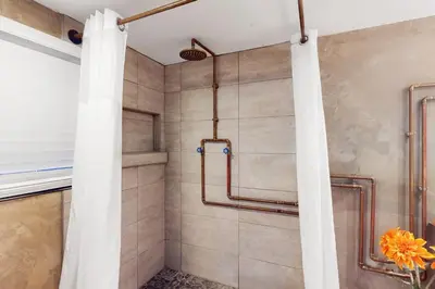 a shower in a bathroom with a shower curtain at Entertainer's Paradise in Fort Lauderdale