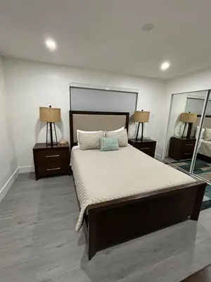 a bedroom with a large bed with two night stands at LaBella Suite in Miami