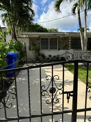 a wrought iron gate in front of a house at LaBella Suite in Miami