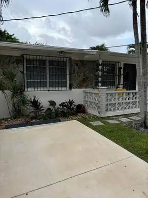 a house with a cement driveway in front of it at LaBella Suite in Miami