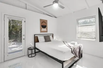 a white bedroom with a bed and a window at Ventur Tropical with Elite Pool & Ultimate Fun Zone in Fort Lauderdale