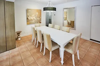 a dining room with a white table and chairs at Private Villa Miami Pool Oasis in Miami