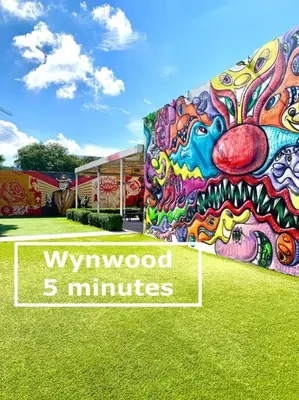 a building covered in graffiti with the words wynwood minutes at B01 Minutes from the beach Studio Midtown Wynwood in Miami