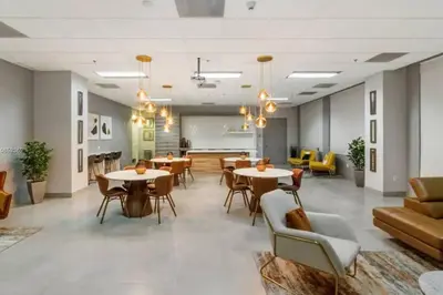 a lobby with tables and chairs in a building at 2 bed condo, Queen sofa bed Brickell, Free Parking, Pool, Gym in Miami