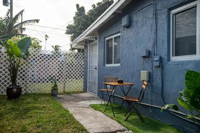 a blue house with a table in the yard at The Myrlande Dinvil Guest Suite in North Miami Beach