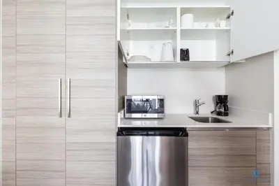 a kitchen with a stainless steel refrigerator and cabinets at Rooftop Pool Balcony Hollywood Beach Broad walk in Hollywood