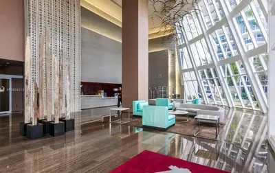 a lobby with a couch and chairs in a building at Luxury High Resort Beautiful Views & Amenities in Hallandale Beach