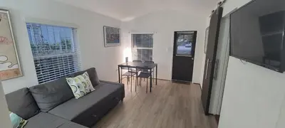 a living room with a couch and a table at Private guest house in the heart of Miami! Surrounded by Miami's HOT spots! in Miami