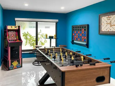 a room with a foosball table and an arcade game at Villa Palma - Prime Location, Pool, Game Room, Outdoor Kitchen in Miami