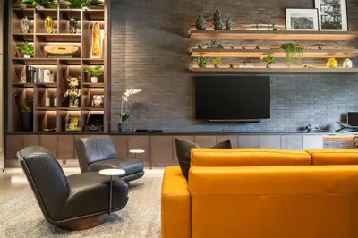 a living room with a yellow couch and a tv at Wynwood Condo, Walk to Restaurants and Nightclubs! in Miami