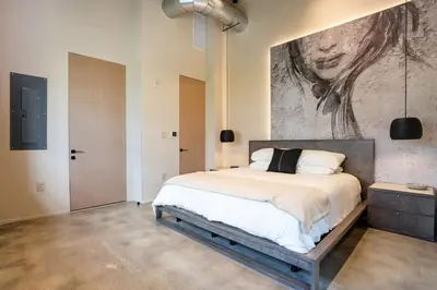 a bedroom with a bed with a painting on the wall at Wynwood Condo, Walk to Restaurants and Nightclubs! in Miami