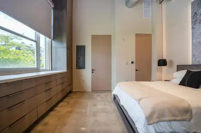 a bedroom with a large bed and a window at Wynwood Condo, Walk to Restaurants and Nightclubs! in Miami