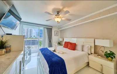a bedroom with a bed and a balcony at Serene View 1 BR in Miami