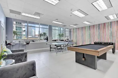 an office with a ping pong table and two tables at Serene View 1 BR in Miami